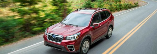 The 2018 Subaru Forester crossover driving down the road.