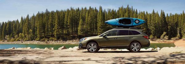Green 2019 Subaru Outback parked lakeside