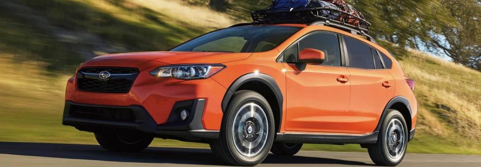Orange 2019 Subaru Crosstrek cruising countryside